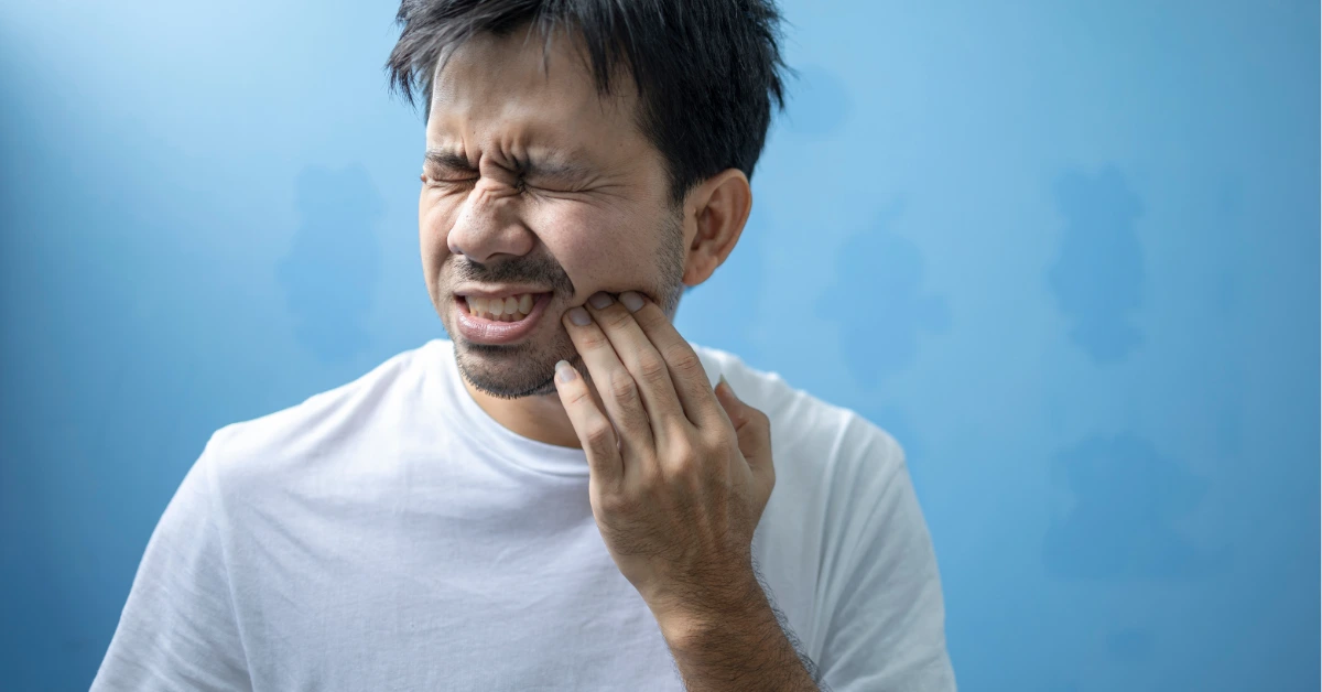 Man experiencing jaw pain after tooth extraction showing discomfort related to granulation tissue healing process