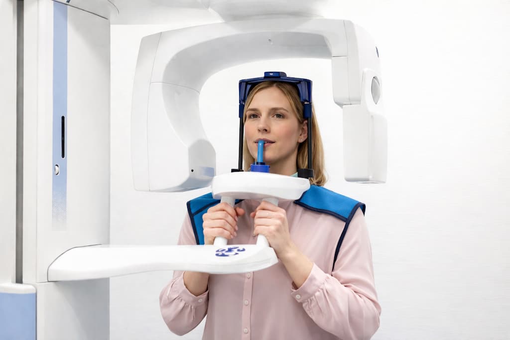 A woman having a 3D scan of teeth for an Invisalign consultation.
